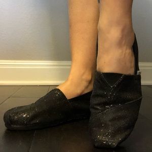 Tom’s black sparkle slip on